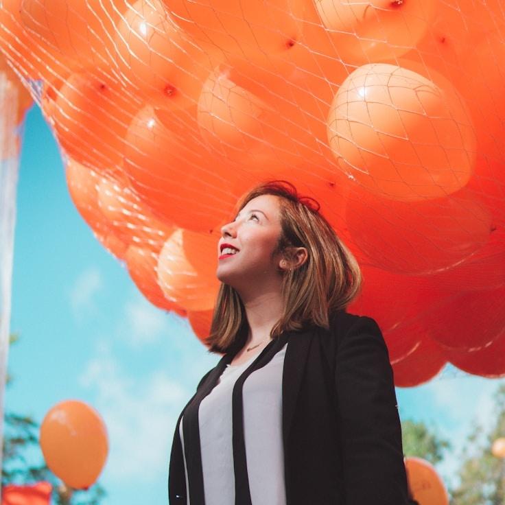 Alexa Chen, Lead Design Curator at Paper Field Harbor, reviewing corporate floral arrangements